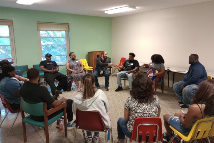 a group sitting in a restorative healing circle.