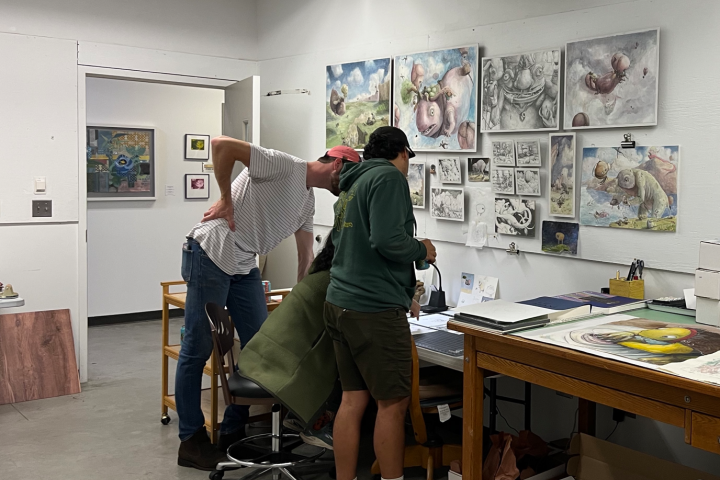 artists working in an art rooml.